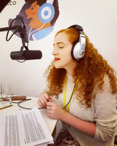 A person wearing headphones and speaking into a microphone