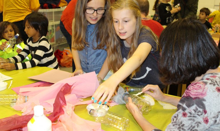 Image of Visitors in a workshop creating with colourful craft materials