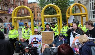 Image of Disabled People Against the Cuts protesters surrounded by police officers outside the Conservative Party conference, Manchester, 14 September 2017. Image courtesy of People's History Museum.