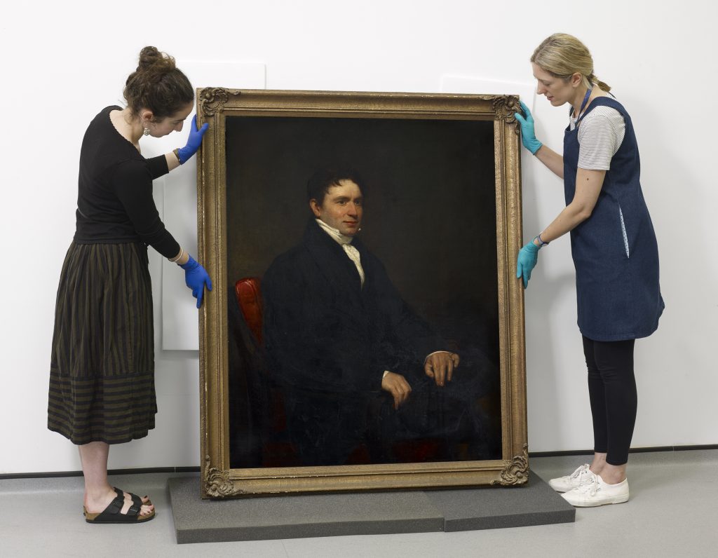 PHM Conservators with Hugh Hornby Birley portrait, oil paint on canvas © People's History Museum