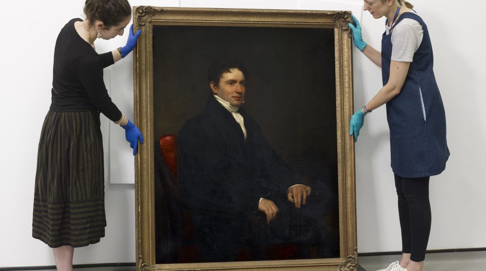 PHM Conservators with Hugh Hornby Birley portrait, oil paint on canvas © People's History Museum