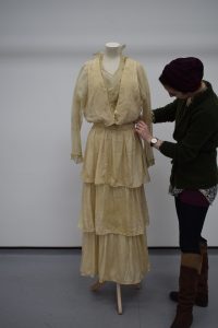 PHM Conservator Kloe Rumsey with Mrs Sutcliffe's wedding dress
