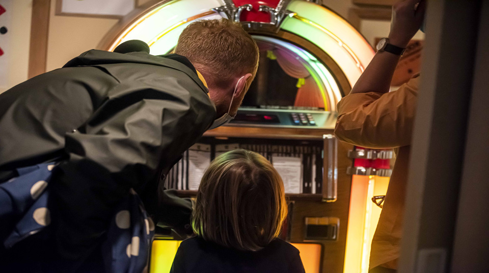 Visitors enjoying the juke box in Main Gallery Two at People's History Museum, Manchester