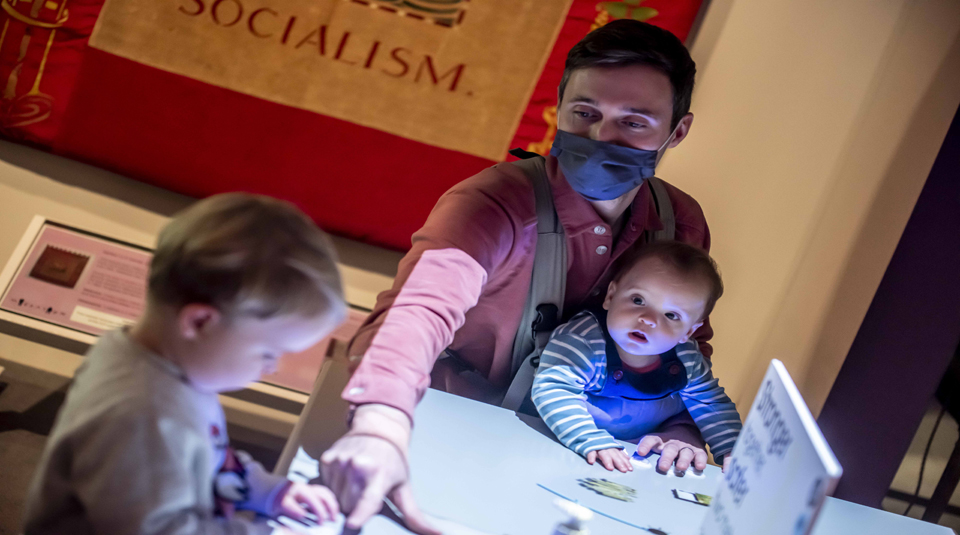 Image of Visitors playing interactive Match Girls' Strike game at People's History Museum, Manchester