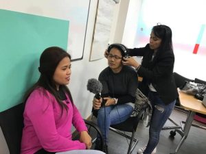 Mimi and two participants interviewing and filming each other during the workshop.© Voice of Domestic Workers
