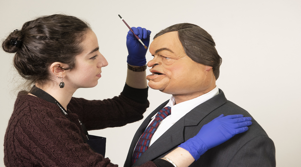Image of PHM's Conservator Kloe Rumsey with ITV show Spitting Image puppet of John Prescott at People's History Museum