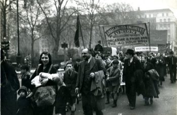 Image of A procession of people with a banner