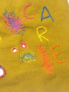 Fabric showing care through repair, by Helen Mather. The Fabric of Protest