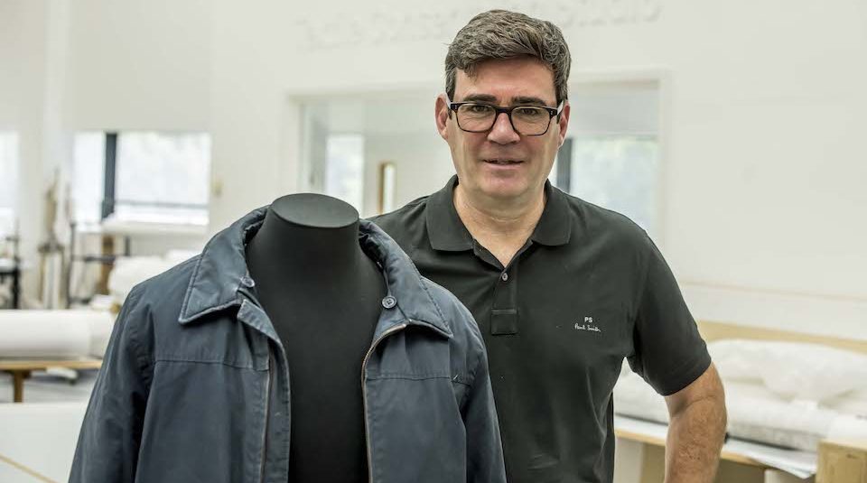 Andy Burnham with Andy Burnham's dark navy workers' jacket in The Conservation Studio at PHM. Image courtesy of People's History Museum