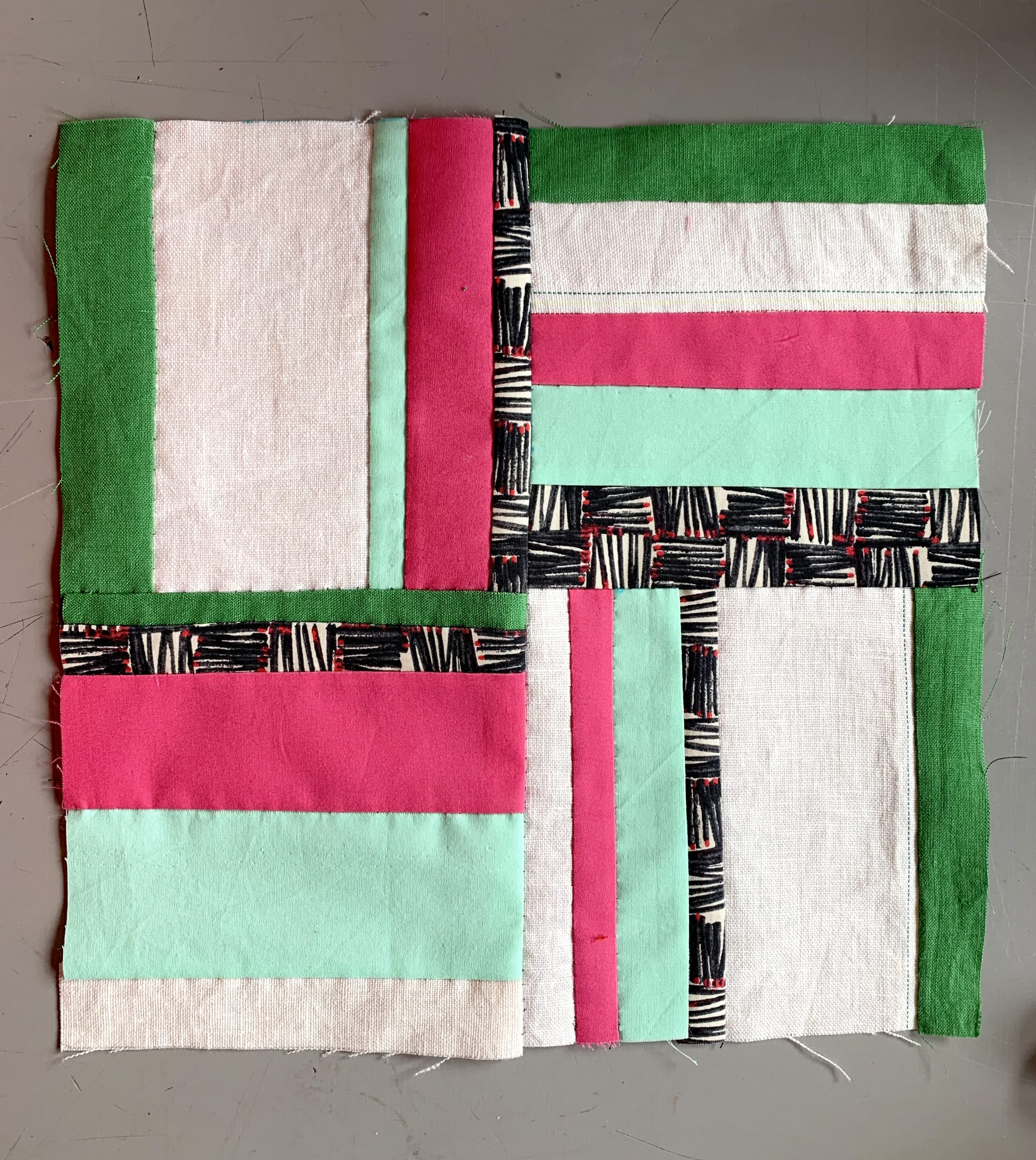 Sat 21 January & Sat 18 March 2023, The Fabric of Protest online workshop creation. Image courtesy of People's History Museum. Square patchwork made from a grid of four smaller square patchworks that are made from strips of green, pink, white and black patterned fabric. 