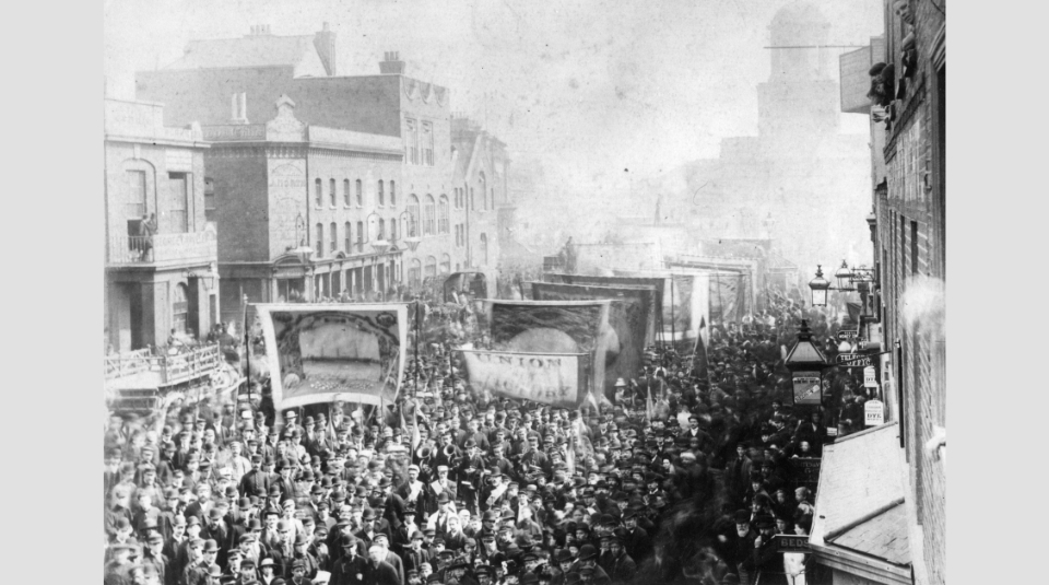 Image of Union and Victory banner being carried at the 1889 Great London Dock Strike. J.K. Collection