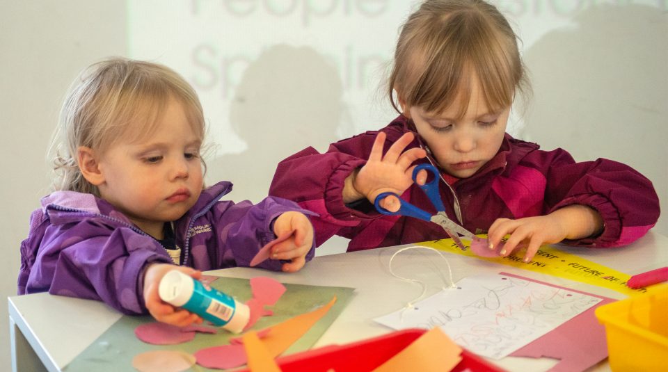Image of Children sticking and cutting in a craft activity at People's History Museum.