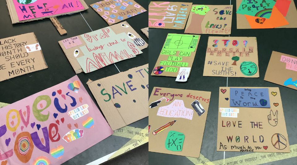Image of Colourful placards with messages which include Love the World and Girls can play football too