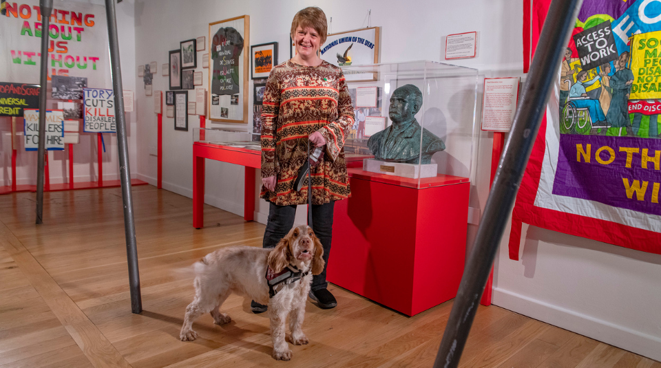 Ruth Malkin, Community Curator at People's History Museum in the Nothing About Us Without Us exhibition with her dog Flint.