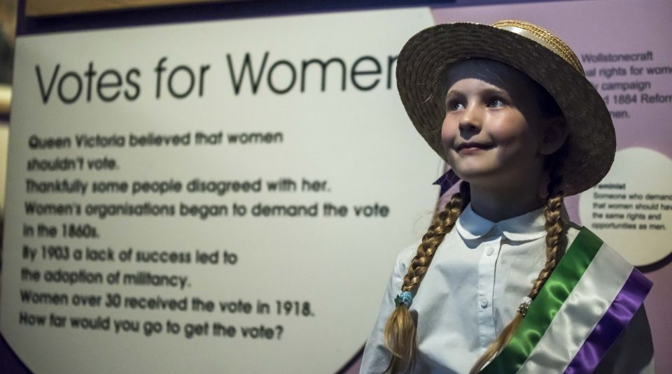 Image of young child in suffragette dress up at People's History Museum.