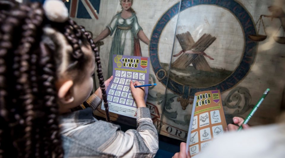 Image of visitors playing 2024 Banner Bingo at People's History Museum.