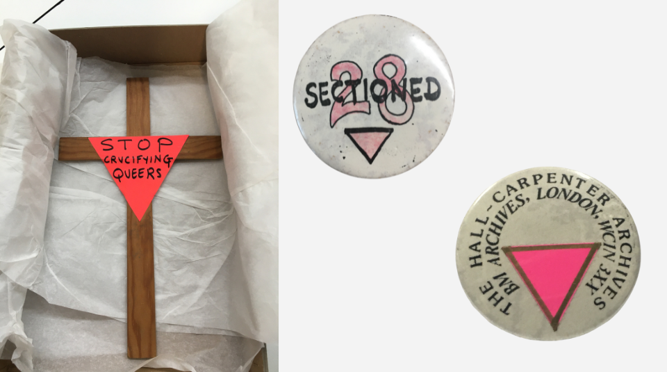 A wooden cross with a paper pink triangle attached to the centre which says 'Stop crucifying queers'. A white badge which says 'Sectioned 28' with a pink triangle below. A white badge with a pink triangle which says 'The Hall-Carpenter Archives BM Archives, London, WC1N 3XX.' 