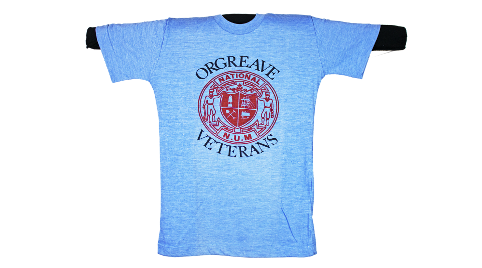 Image of Blue t shirt with a red logo. The text reads: ‘Orgreave Veterans, National N.U.M’.