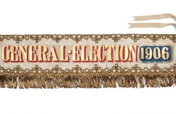 Image of Landscape banner with gold fringing, embroidery, and lettering reading: 'General Election 1906'.