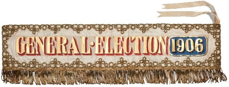 Landscape banner with gold fringing, embroidery, and lettering reading: 'General Election 1906'.