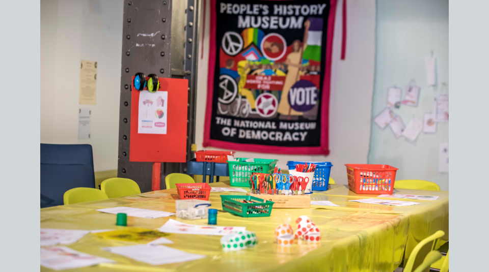 Image of A craft activity table with a People's History Museum banner