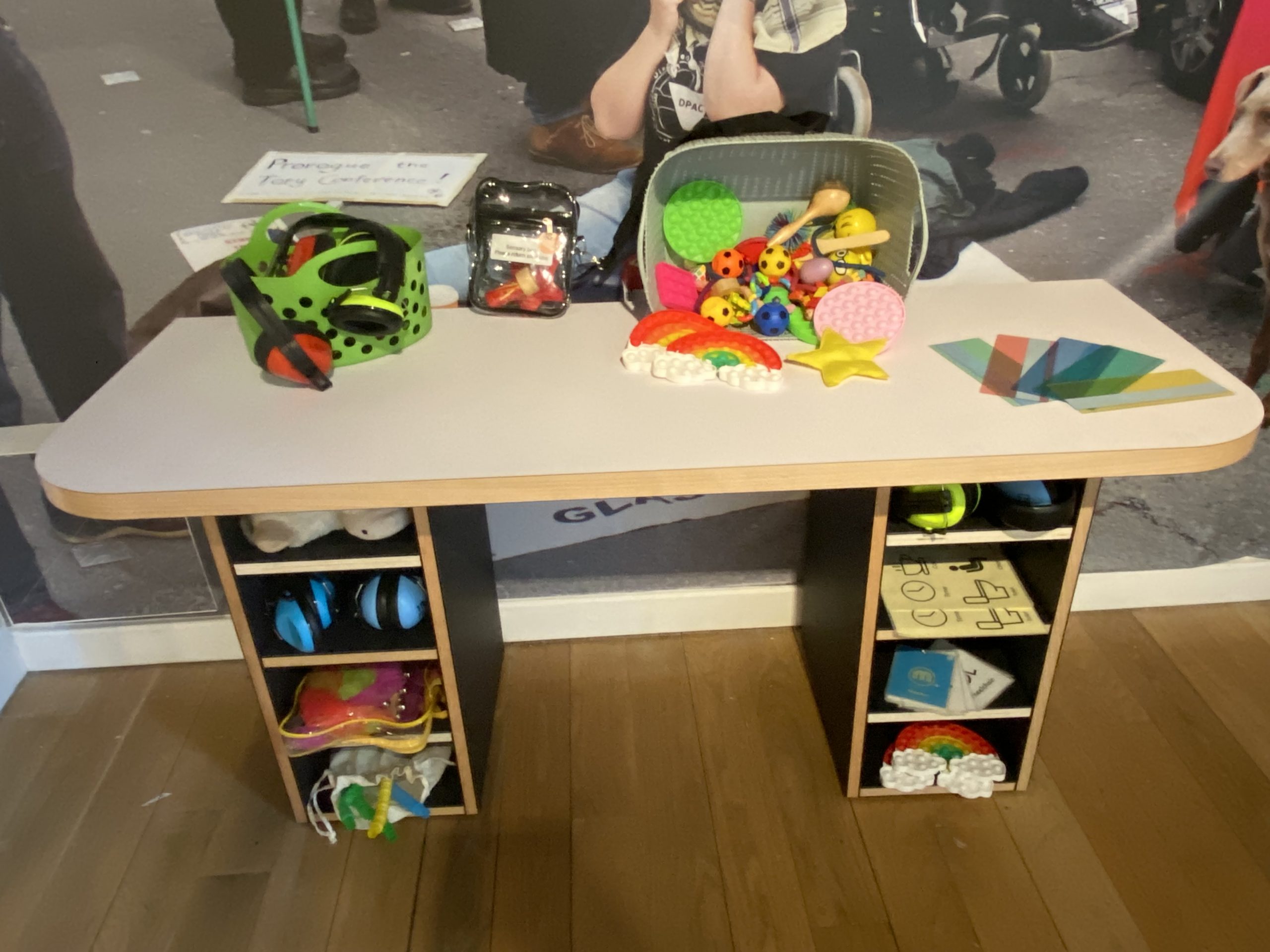 Desk with colourful sensory tools on top and in pigeon holes below.