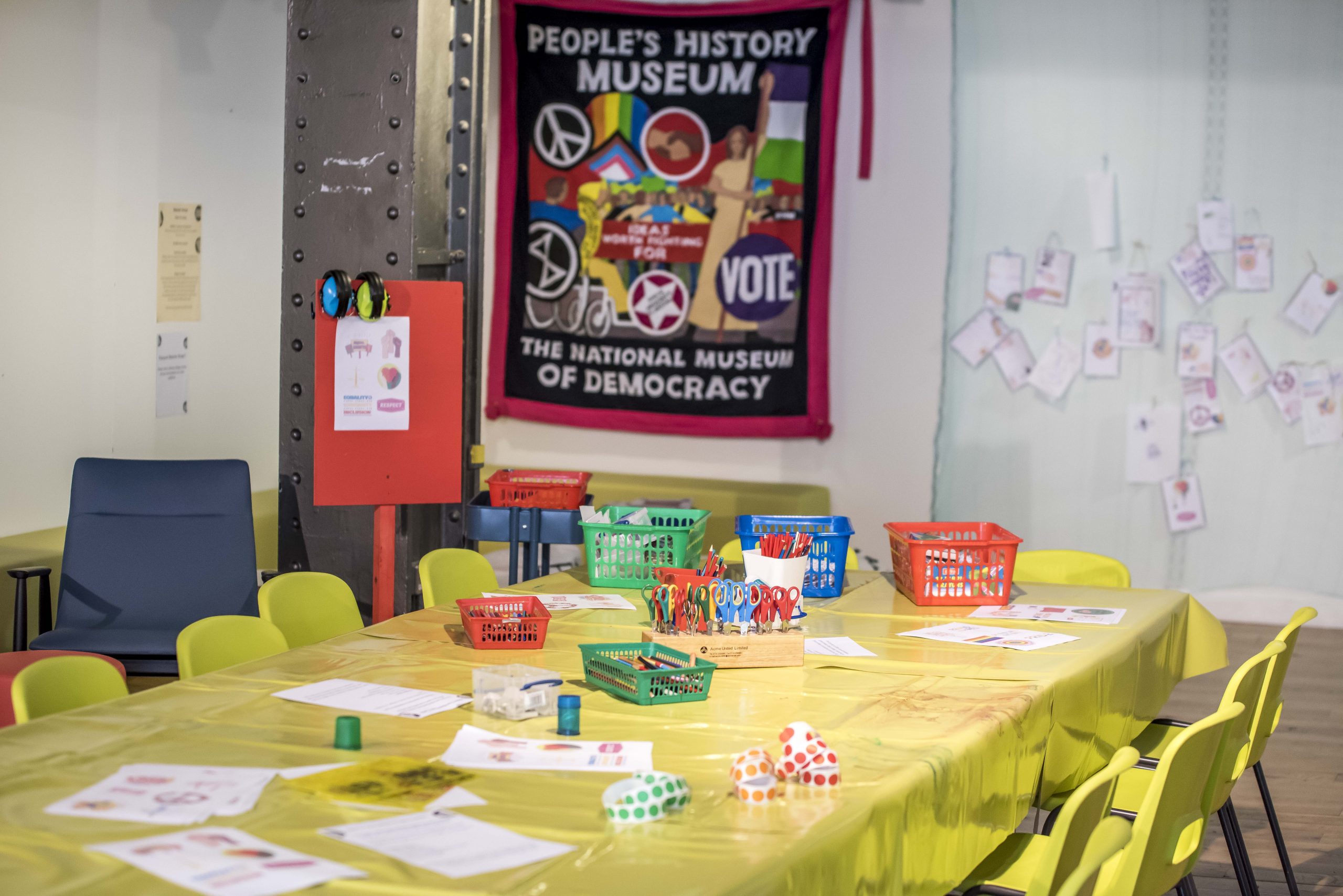 A colourful space with tables and chairs and craft activities.