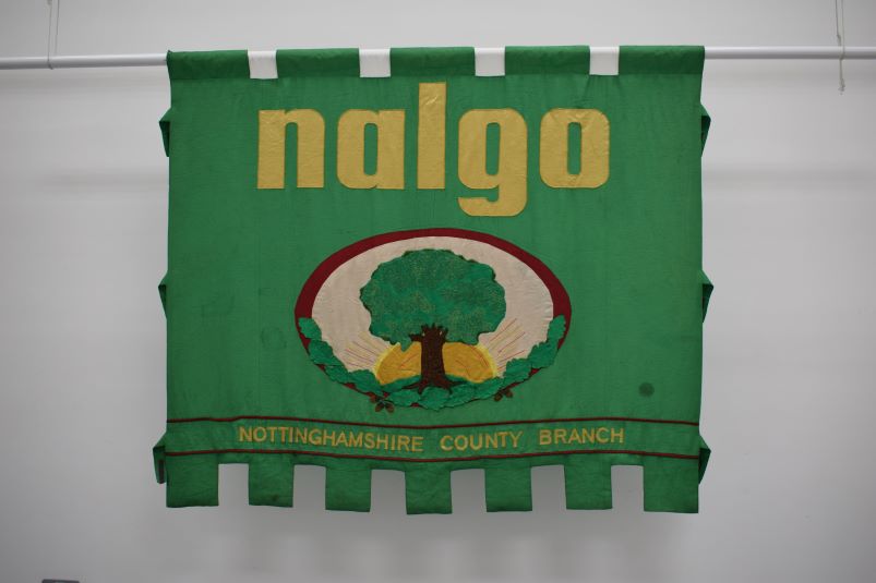 Image of Green banner with a tree in the centre. The gold text reads: nalgo