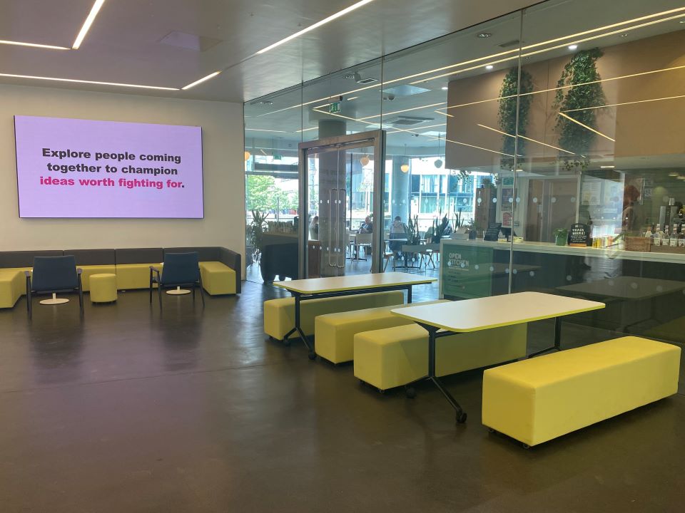 Chairs, stools, benches, and tables in the foyer of People's History Museum.