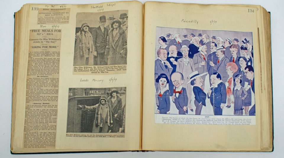 Image of An open scrapbook including black and white newspaper cuttings and photographs, and a colourful illustration.