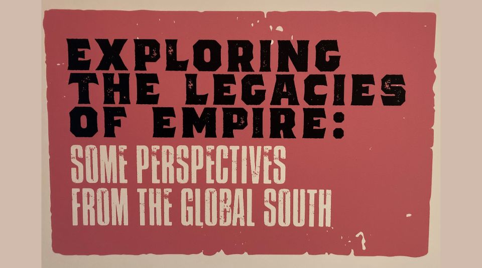 Image of Red exhibition board, the text in black and white reads Exploring the Legacies of Empire: Some Perspectives from the Global South