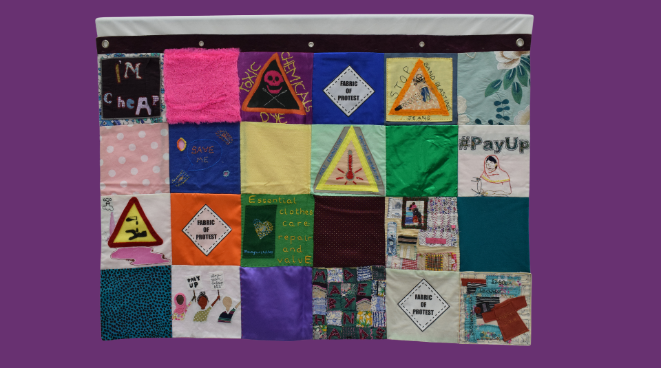 Image of Colourful patchwork banner including a mix of textiles, text, symbols, and pictures.