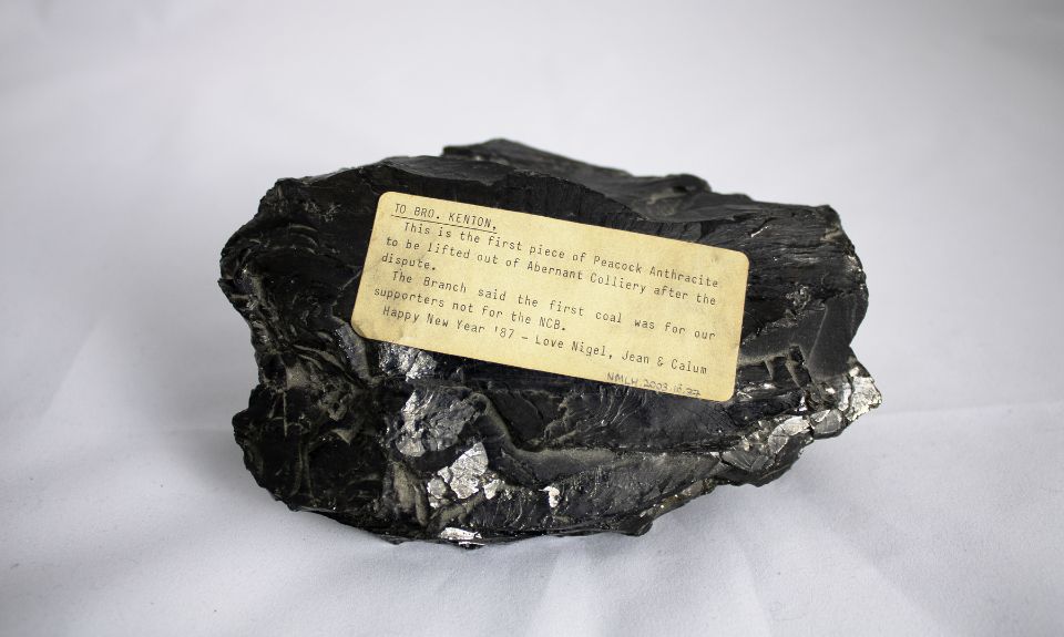 Piece of black coal with a cream label attached