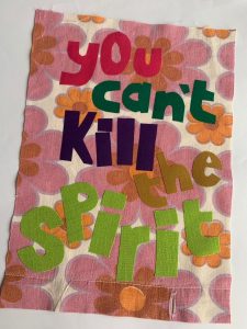 A small fabric banner. The text reads You can't kill the spirit