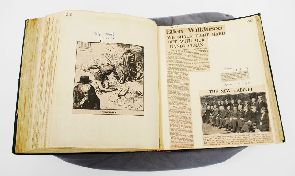 An open book with newspaper cuttings.