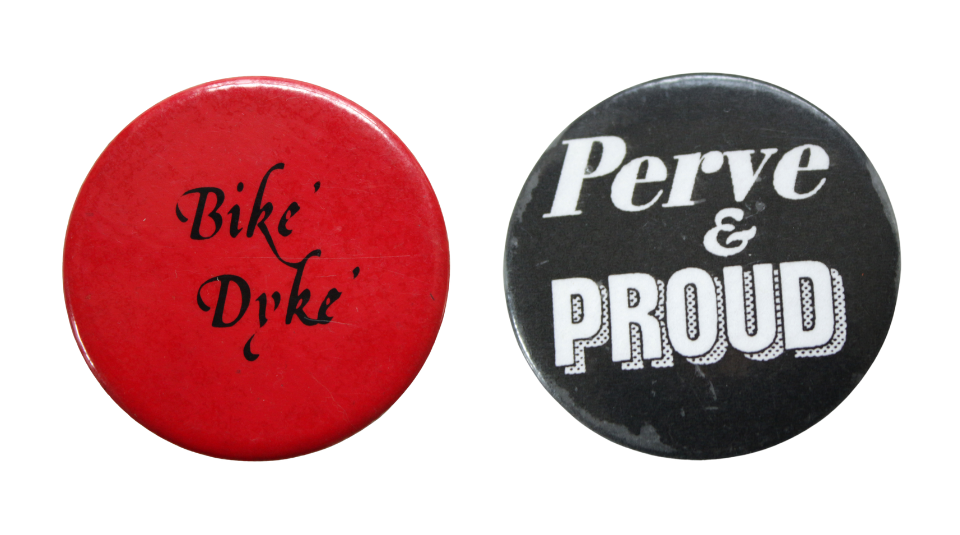 Red badge with ’Bike Dyke’ in black and a round black badge, ‘Perve and proud’ in white.