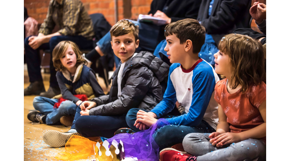 Image of A group of children sitting on the floor