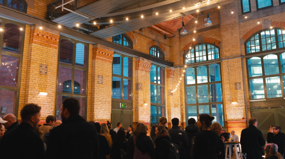 Image of A large room filled with festoon lights and people
