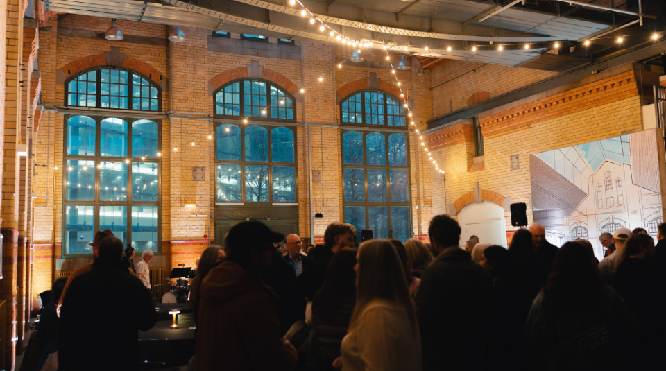 Image of A large room filled with festoon lights and people
