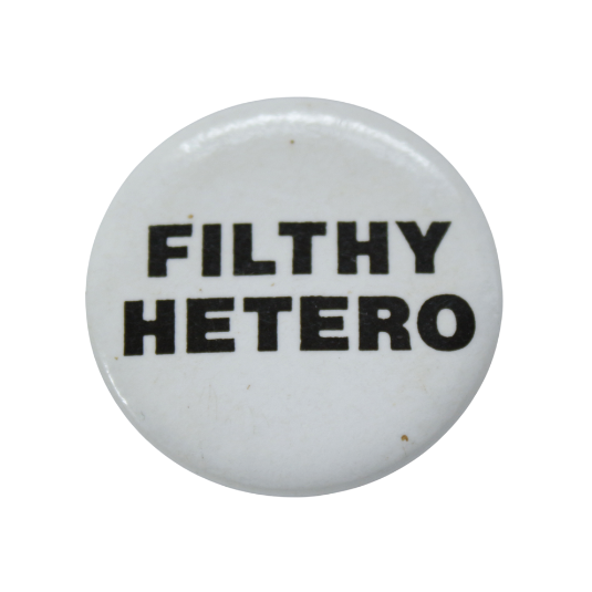 Round white badge, with ‘FILTHY HETERO’ in black.