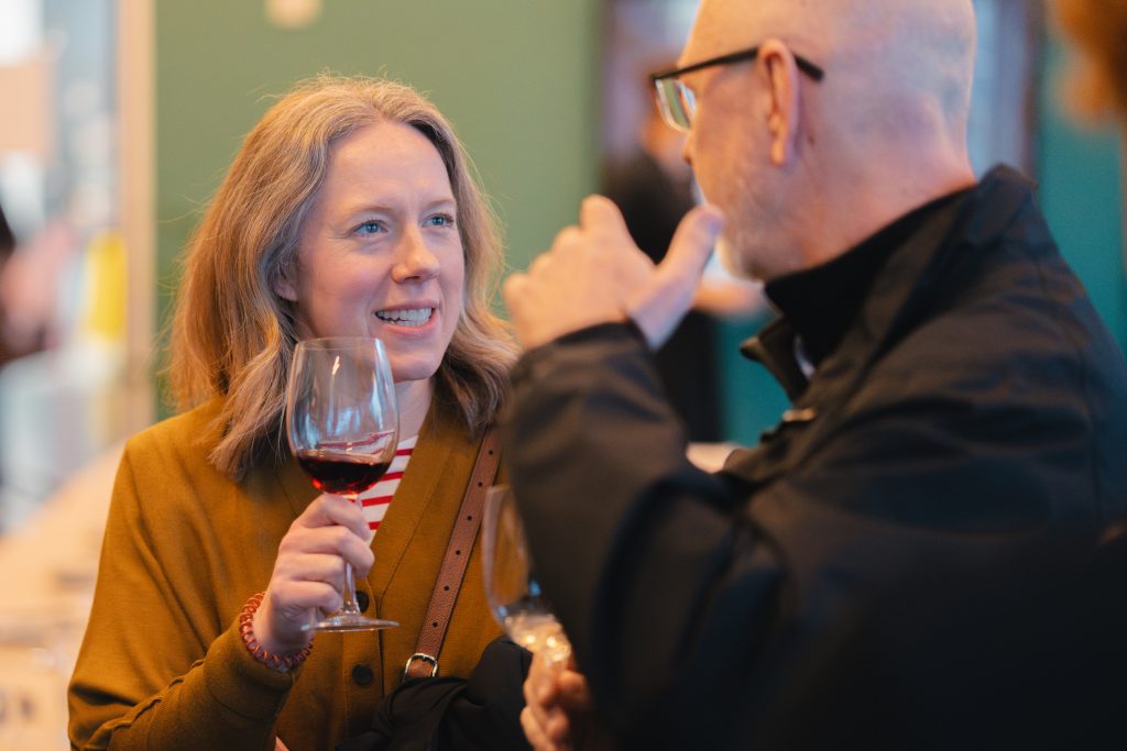 Two people holding wine glasses