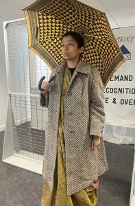 a person wearing a coat and holding an umbrella