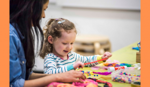 Image of An adult and child sat at a craft table
