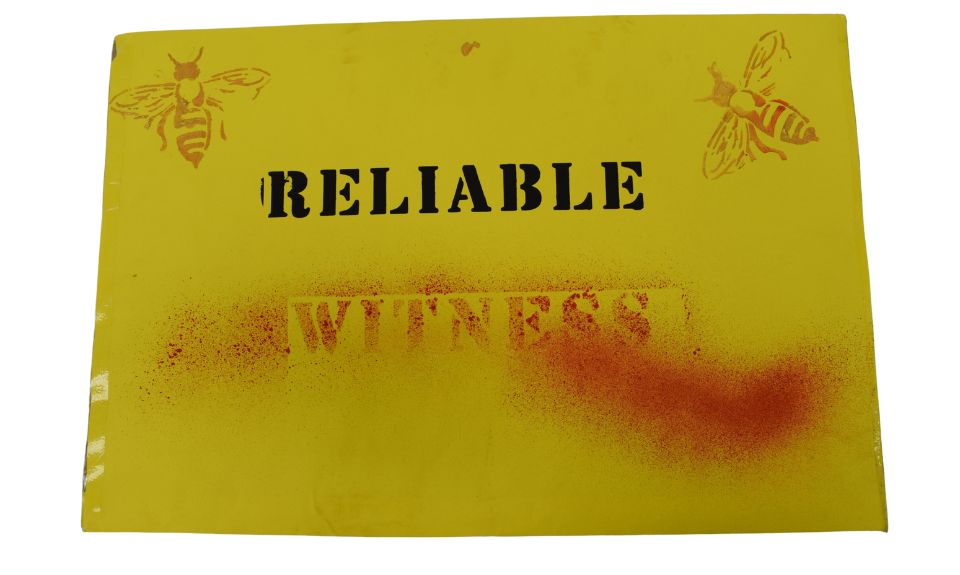 Mendip House scandal 'Reliable Witness' placard, 2019. NMLH.2024.41.3.1 A yellow sign with stencilled bees. The text reads Reliable Witness