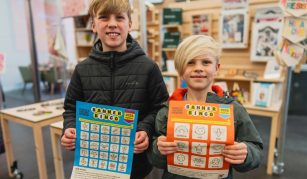 Image of Photograph of two children holding colorful Banner Bingo sheets