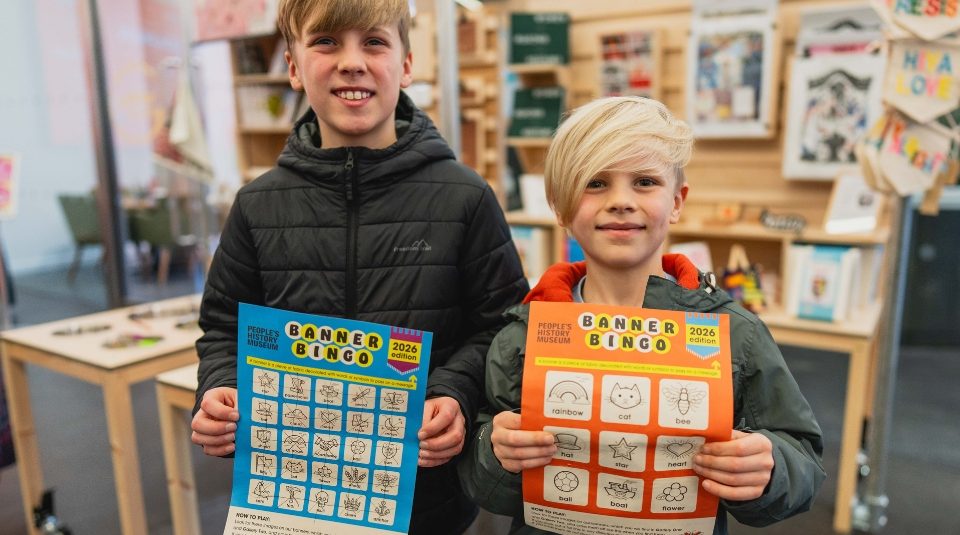 Image of Photograph of two children holding colorful Banner Bingo sheets