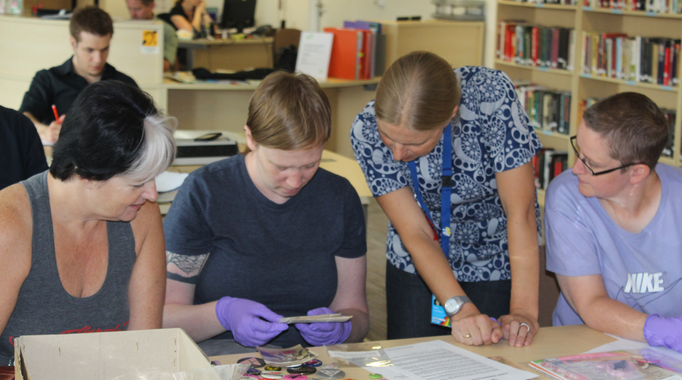 Image of A group of people looking at archive and collection items