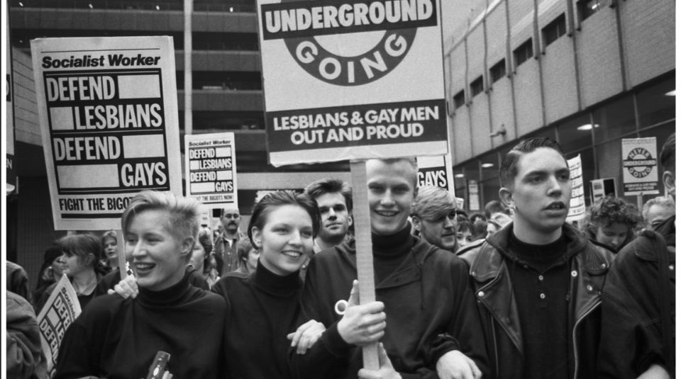 A black and white photo of a crowd holding placards