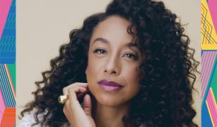 Image of Colour photograph of a woman with long curly hair and bright lipstick.