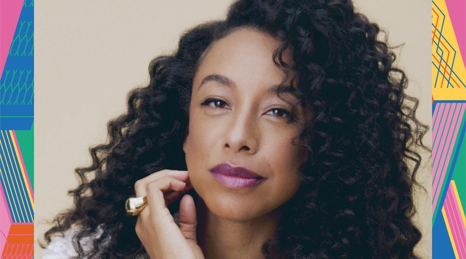 Image of Colour photograph of a woman with long curly hair and bright lipstick.